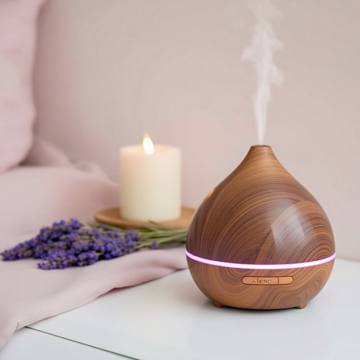 Ein stilvoller Holz-Diffuser, aus dem sanfter Dampf aufsteigt, steht auf einem weißen Tisch. Daneben liegen frische Lavendelblüten und eine brennende weiße Kerze auf einem Holzuntersetzer. Die Szene vermittelt eine beruhigende und entspannende Atmosphäre.